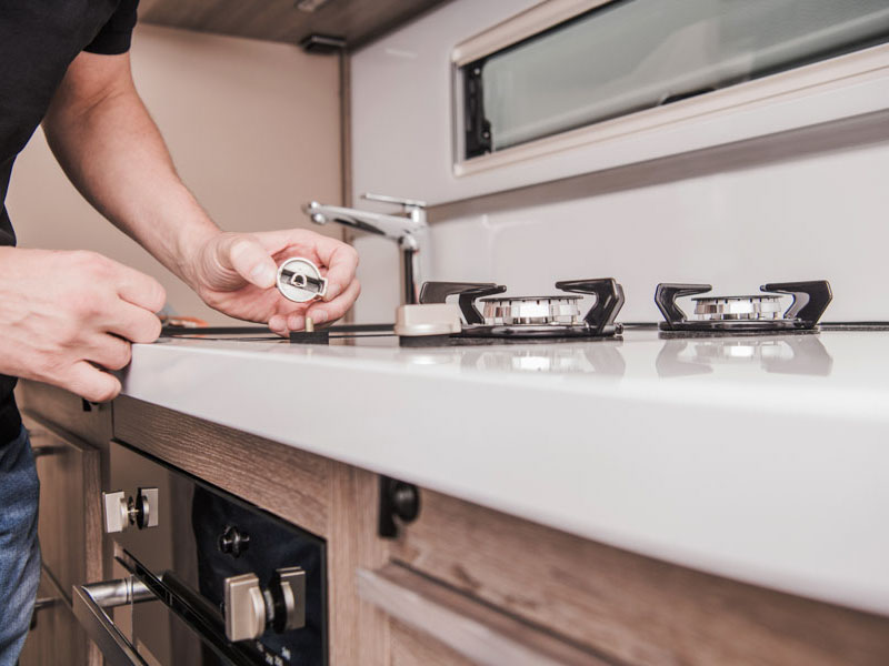 Motorhome Stove Problem. Repairing and Replacement Broken Elements Inside Recreational Vehicle. After Season Maintenance.