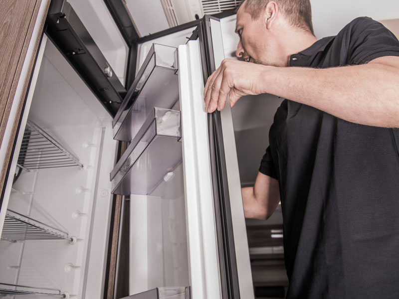 Refrigerator Replacing Inside Camper RV Motorhome by Caucasian Appliances Technician.